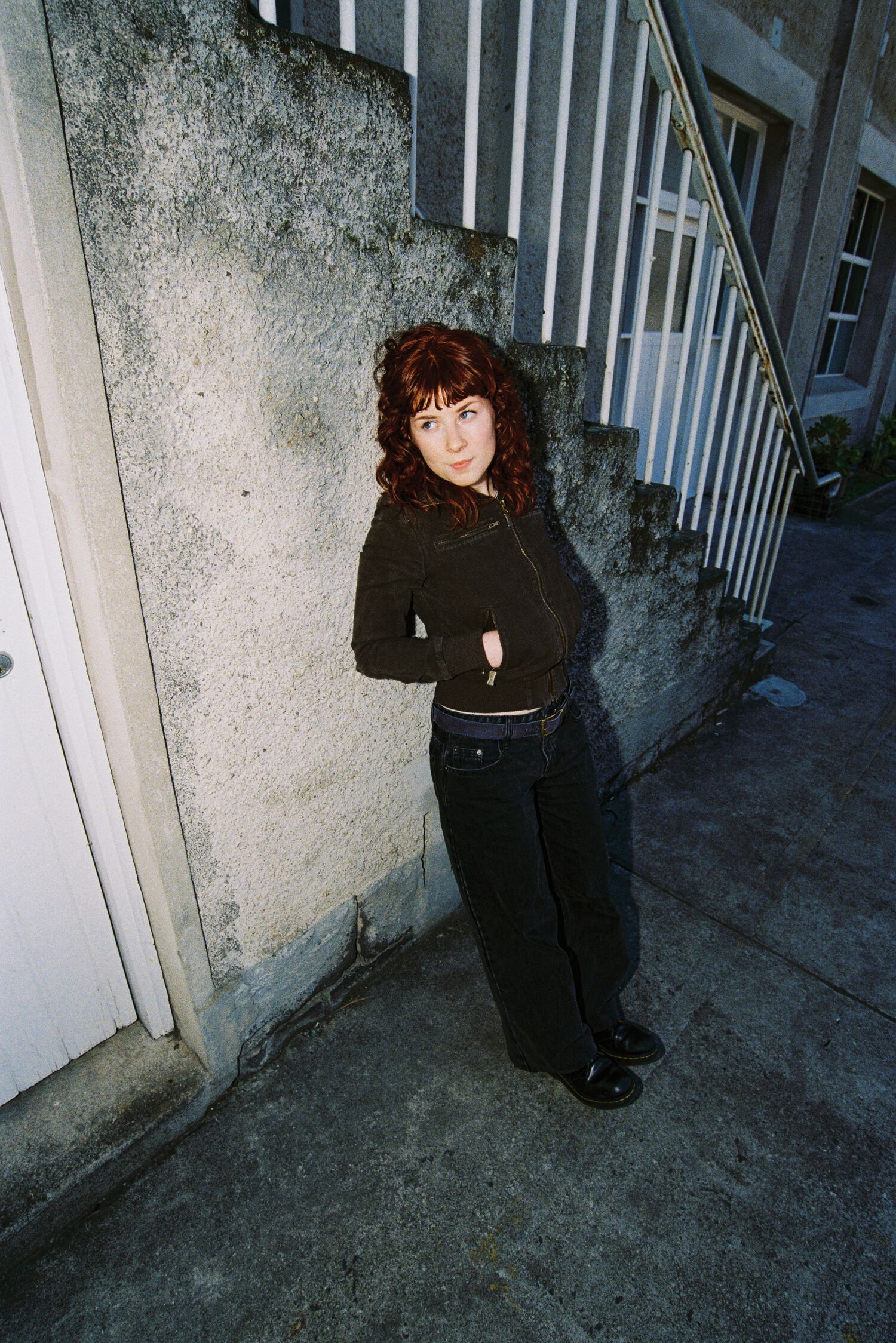 Lucky leaning against a staircase